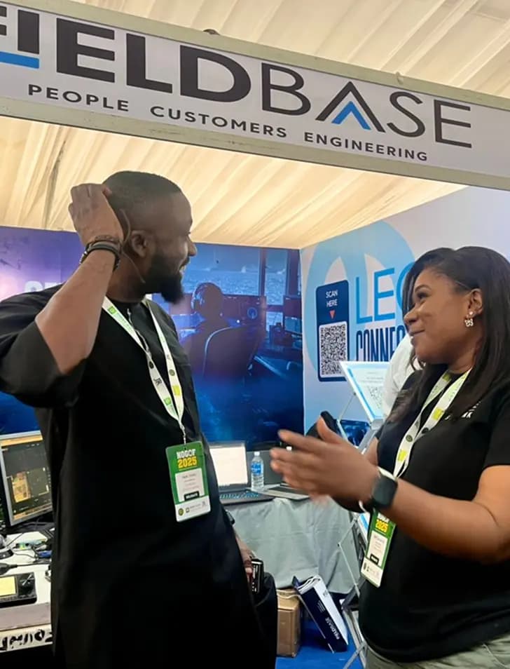 Colleagues representing Fieldbase at an exhibition stand with Fieldbase signage